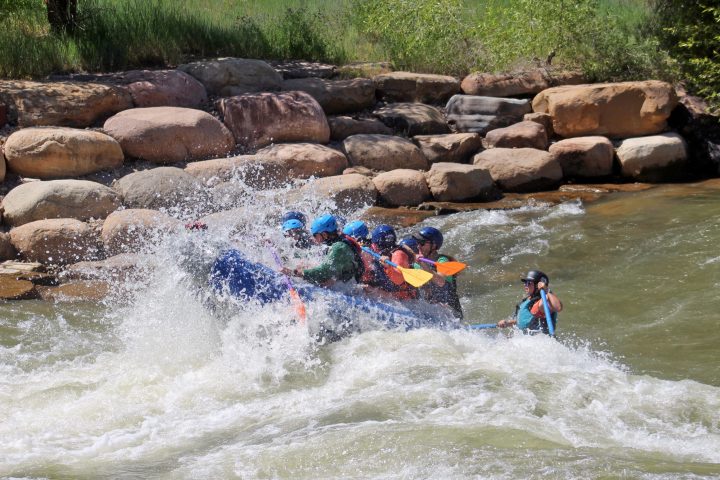 a group of people on a raft in a body of water