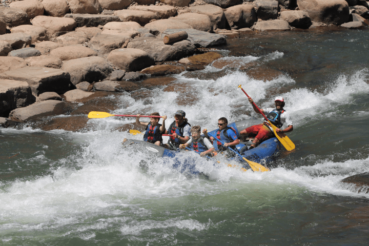 group of people rafting down a white water river