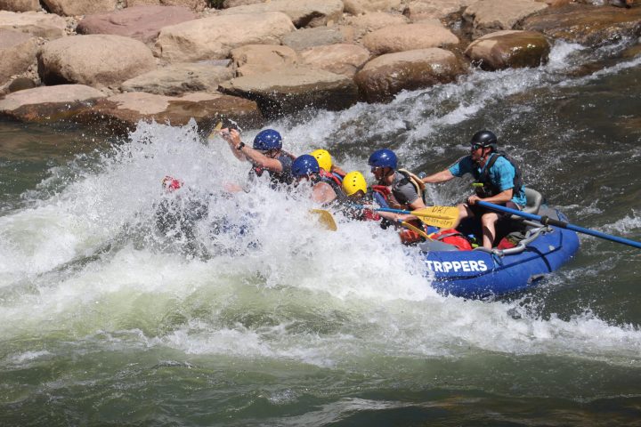 a group of people on a raft in a body of water